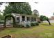 Backyard view of home featuring a charming sunroom and landscaped greenery at 723 Rabun Ln, Rock Hill, SC 29730