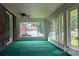 Spacious sunroom with large windows, green carpet, and a ceiling fan at 723 Rabun Ln, Rock Hill, SC 29730