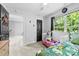 Bright bedroom with door to hallway features a twin bed and large window offering natural light at 7321 Mapleridge Dr, Charlotte, NC 28210