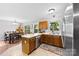 Kitchen featuring counter seating and seamless flow to the dining area at 7321 Mapleridge Dr, Charlotte, NC 28210