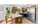 Well-lit kitchen with stainless steel appliances and barstool seating at 7321 Mapleridge Dr, Charlotte, NC 28210