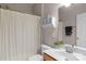 Cozy bathroom features a shower with a curtain, a white vanity, and matching toilet at 7501 Cleyera Cir, Waxhaw, NC 28173