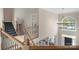 Elegant foyer with an open staircase, wrought iron railings, and a stunning chandelier hanging from the tall ceilings at 7501 Cleyera Cir, Waxhaw, NC 28173