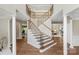 Grand foyer features a stunning staircase with iron railings and elegant architectural details at 7501 Cleyera Cir, Waxhaw, NC 28173