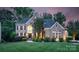 Elegant brick home boasts a manicured lawn, lush landscaping, and inviting curb appeal at 7501 Cleyera Cir, Waxhaw, NC 28173
