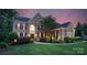 Inviting brick home featuring a well-manicured lawn, mature trees, and classic design at 7501 Cleyera Cir, Waxhaw, NC 28173