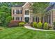 Beautiful brick home featuring a manicured lawn, lush landscaping, and a welcoming front entrance at 7501 Cleyera Cir, Waxhaw, NC 28173