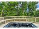 Inviting hot tub on the deck with built-in seating and privacy railing at 7501 Cleyera Cir, Waxhaw, NC 28173