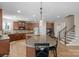 Spacious kitchen featuring dark wood cabinets, granite countertops, and modern stainless steel appliances at 7501 Cleyera Cir, Waxhaw, NC 28173