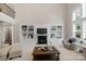 Inviting living room with custom built-ins, a cozy fireplace, and large windows offering picturesque views at 7501 Cleyera Cir, Waxhaw, NC 28173