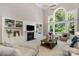 Bright living room boasts built-in bookshelves, a fireplace, and large windows for ample natural light at 7501 Cleyera Cir, Waxhaw, NC 28173
