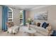 Cozy living room featuring a comfortable sofa with accent pillows, elegant decor, and natural light from the windows at 7501 Cleyera Cir, Waxhaw, NC 28173
