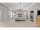 Bright main bedroom with neutral color palette, tray ceiling, and access to an en-suite bathroom through an open doorway at 7501 Cleyera Cir, Waxhaw, NC 28173