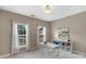 Bright home office space with natural light, featuring a white desk and shelving for a clean and modern workspace at 7501 Cleyera Cir, Waxhaw, NC 28173