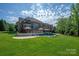 Sprawling backyard featuring an inground pool, lush lawn, and mature trees at 7507 Meadowgate Ln, Waxhaw, NC 28173
