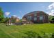Expansive backyard featuring a well-maintained lawn, pool, deck, and patio, perfect for outdoor entertaining at 7507 Meadowgate Ln, Waxhaw, NC 28173