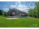 Expansive backyard featuring a pool, patio, deck, and lush green lawn for outdoor enjoyment at 7507 Meadowgate Ln, Waxhaw, NC 28173