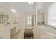 Elegant primary bathroom with dual vanities, soaking tub, walk-in shower, and natural light from a large window at 7507 Meadowgate Ln, Waxhaw, NC 28173