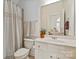 Bright bathroom with white vanity, mirrored wall cabinet, and shower with curtain at 7507 Meadowgate Ln, Waxhaw, NC 28173