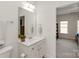 Bathroom featuring a toilet and vanity with a mirror reflecting into a nearby bedroom at 7507 Meadowgate Ln, Waxhaw, NC 28173