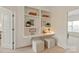 Cozy home office nook with built-in shelving, a desk, and comfortable seating at 7507 Meadowgate Ln, Waxhaw, NC 28173