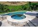 Custom in-ground pool with a built-in hot tub and lush landscaping at 7507 Meadowgate Ln, Waxhaw, NC 28173