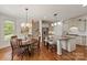 An open floor plan with wood floors, a kitchen, a dining area, and a staircase at 7507 Meadowgate Ln, Waxhaw, NC 28173