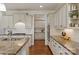 Gourmet kitchen with stainless steel appliances, granite countertops, and custom cabinetry for cooking and entertaining at 7507 Meadowgate Ln, Waxhaw, NC 28173