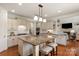 Modern eat-in kitchen with granite countertops, stainless steel appliances, and a large central island with seating at 7507 Meadowgate Ln, Waxhaw, NC 28173