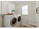 Well-lit laundry room with front load washer and dryer, white cabinets, and a convenient utility sink at 7507 Meadowgate Ln, Waxhaw, NC 28173
