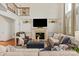 Bright and airy living room featuring a fireplace, built-in shelving, and large windows with elegant drapery at 7507 Meadowgate Ln, Waxhaw, NC 28173