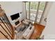 Airy living room with tall windows, fireplace, hardwood floors, and comfortable seating at 7507 Meadowgate Ln, Waxhaw, NC 28173