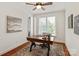 Stylish home office with natural light, hardwood floors, a ceiling fan, and a decorative area rug at 7507 Meadowgate Ln, Waxhaw, NC 28173