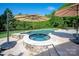 Backyard pool and hot tub area with stone patio and lush greenery at 7507 Meadowgate Ln, Waxhaw, NC 28173