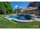 Beautiful inground pool featuring a waterfall feature and lounge chairs at 7507 Meadowgate Ln, Waxhaw, NC 28173