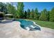 Beautiful in-ground pool with lounge chairs and surrounding greenery for a private backyard retreat at 7507 Meadowgate Ln, Waxhaw, NC 28173