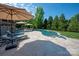 Pool patio with lounge chairs and umbrellas, perfect for relaxation and outdoor entertaining at 7507 Meadowgate Ln, Waxhaw, NC 28173