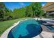 Inground pool with stone surround, waterfall, and beautiful landscaping at 7507 Meadowgate Ln, Waxhaw, NC 28173