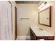 Bathroom featuring a vanity with sink, a mirror, shower with curtains, and a storage cabinet at 8024 Bradford Ln, Denver, NC 28037