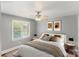 A staged bedroom offers a comfortable retreat with natural light at 8024 Bradford Ln, Denver, NC 28037
