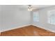 This bedroom is bright with hardwood floors and a ceiling fan at 8024 Bradford Ln, Denver, NC 28037
