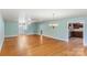 Expansive room with gleaming hardwood floors and neutral paint, leading into the kitchen at 8024 Bradford Ln, Denver, NC 28037