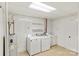 Functional laundry room with washer, dryer, utility sink, and ample storage space at 8024 Bradford Ln, Denver, NC 28037