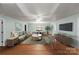 Bright living room featuring hardwood floors, neutral paint, and a comfortable seating area at 8024 Bradford Ln, Denver, NC 28037