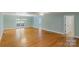 Large living room featuring hardwood floors and access to a sunroom at 8024 Bradford Ln, Denver, NC 28037