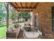 Enjoy the outdoors on this covered porch with stylish furniture at 8024 Bradford Ln, Denver, NC 28037