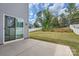 Spacious backyard with patio, privacy fence, and sliding glass doors at 8726 Addingham Dr, Charlotte, NC 28269
