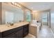 Well-appointed bathroom with a soaking tub, marble countertop, and dark wood cabinets at 8726 Addingham Dr, Charlotte, NC 28269