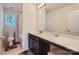 Well-lit bathroom featuring a vanity with marble countertop, a toilet, and a shower with a curtain at 8726 Addingham Dr, Charlotte, NC 28269