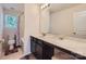 Bright bathroom vanity features marble countertops, dark cabinetry, and modern fixtures at 8726 Addingham Dr, Charlotte, NC 28269